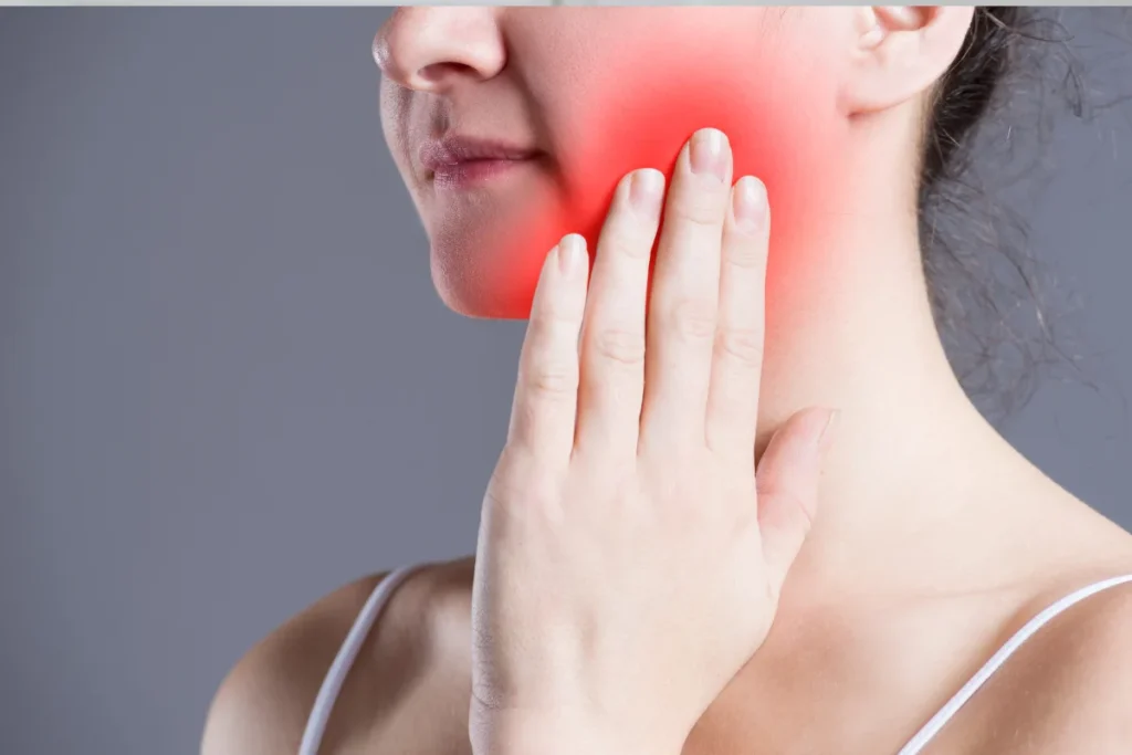 Woman experiencing jaw pain from impacted wisdom teeth needing removal
